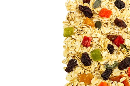 Cereal muesli or oat flakes with dried fruit, studio isolated on white background with space for textの写真素材