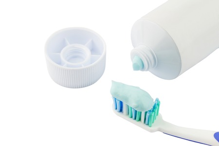 Toothbrush beside toothpaste isolated on white backgroundの写真素材