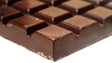 Black chocolate bar isolated on white background, close-up viewの写真素材