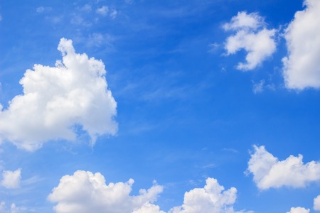 Blue sky background with white fluffy clouds