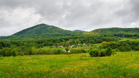 Carpathian mountains, before rain in cloudy day. houses in valley under hill. Ukraineの写真素材