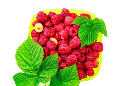 Bowl full of ripe raspberries isolated on white background, top view