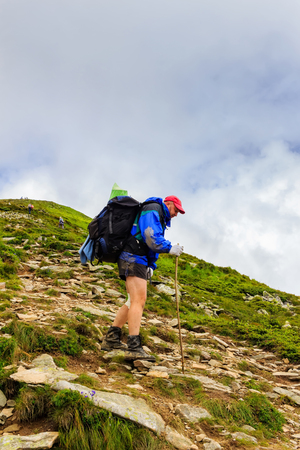 Tourist with a backpack down from mountain, Carpathians, Ukraineの写真素材