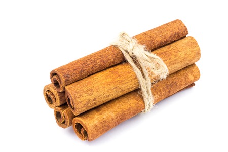 Group of cinnamon sticks isolated on white background, close-upの写真素材