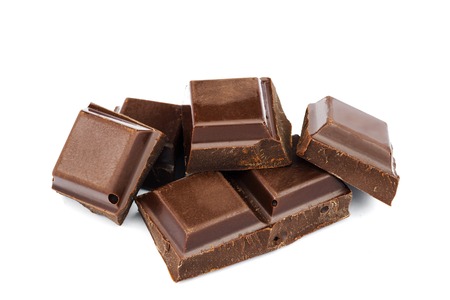 Dark chocolate cubes isolated on white backgroundの写真素材