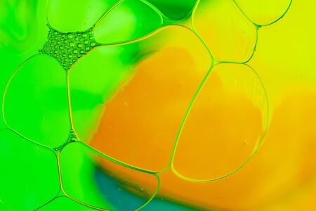 Oil drops floating in water abstract multi color backgroundの写真素材
