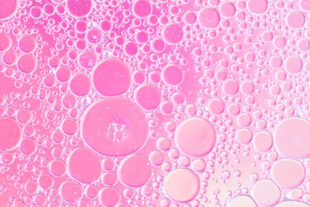 Oil drops floating in water abstract multi color backgroundの写真素材