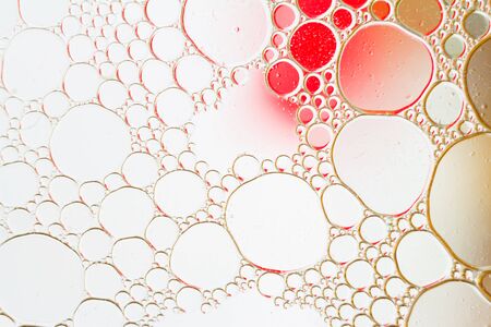 Oil drops floating in water abstract multi color backgroundの写真素材