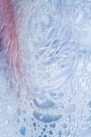 Oil drops floating in water abstract multi color background