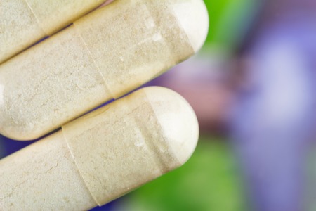 Glucosamine capsules, food supplement pills, top view, macro image