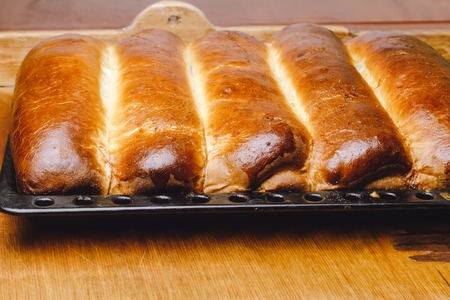 Hot, fresh baked homemade sweet pies, strudel on baking panの写真素材