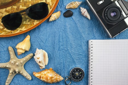 Top view, sea and travel concept with summer holiday accessories, vintage camera, sunglasses, seashellsの写真素材