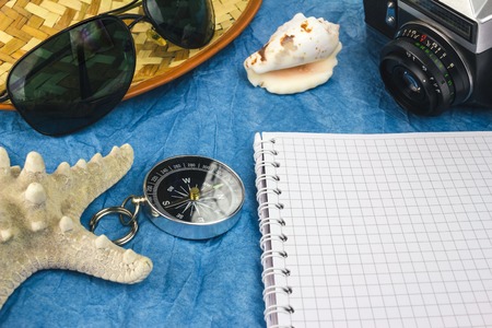 Sea and travel concept with summer holiday accessories, vintage camera, sunglasses, seashellsの写真素材