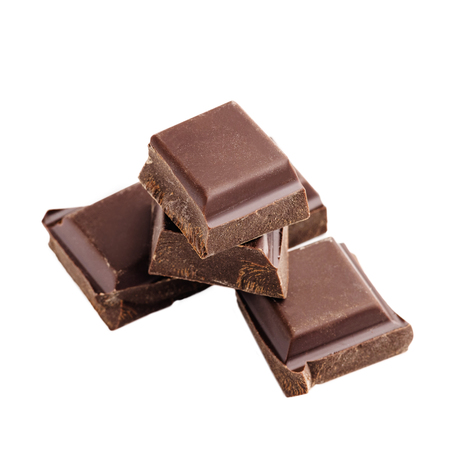 Pieces of bitter, dark chocolate bar, cubes on heap, isolated on white background, close-up view.の写真素材