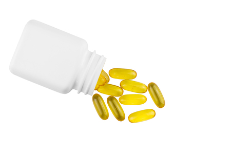 Yellow capsules omega 3, fatty acid, fish oil and bottle, container isolated on white background, top view.の写真素材