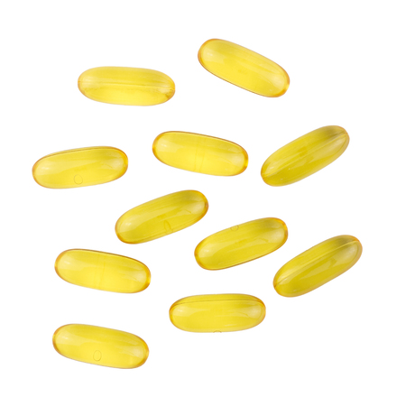 Yellow capsules omega 3, fatty acid, fish oil isolated on white background, top view.の写真素材