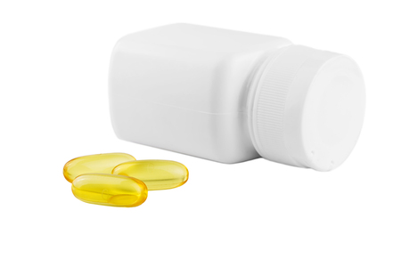 Yellow capsules omega 3, fatty acid, fish oil and bottle, container isolated on white background.の写真素材