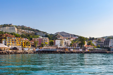 Apartment buildings on seashore in balchik city on black sea coast in Bulgaria at sunny summer day.の写真素材