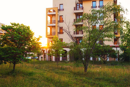 Backyard or terrace of the resort apartment buildings in golden light at sunset time.の写真素材