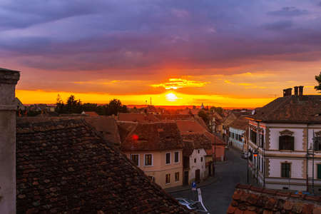 Awesome scenery of sunset over the ancient european city Sibiu in Romania.の写真素材
