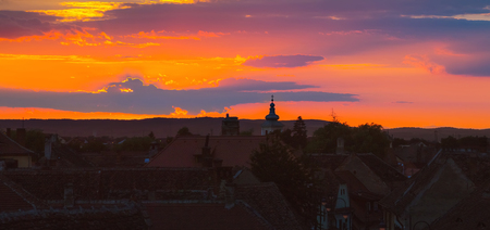 Awesome scenery of sunset over the ancient european city Sibiu in Romania.の写真素材
