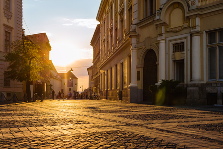 Large, main square Huet with City Hall and people on the street at golden sun light, ancient, medieval city Sibiu, Romania.の写真素材
