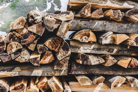 Pile of firewood, stack of chopped tree logs, outdoors.の写真素材
