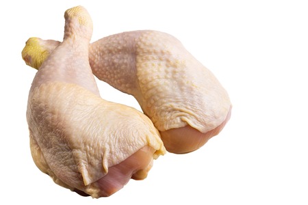 Two fresh, raw chicken legs or thighs isolated on white background.の写真素材
