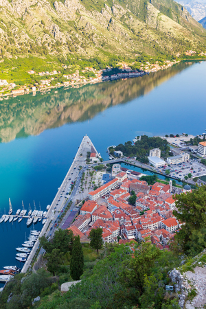 View from above on old historical city Kotor with orange tile roofs in adriatic sea coastline, morning time, Montenegro.の写真素材