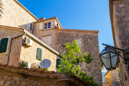 Facade of old historical buildings at ancient city Budva, Montenegro, low angle of view.の写真素材