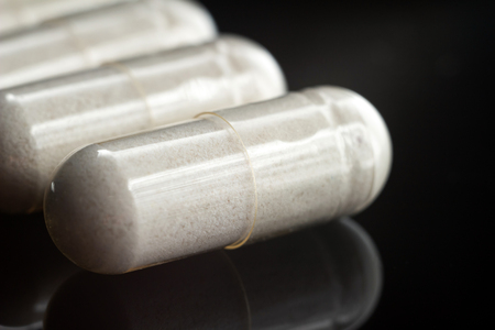 White medical capsules of glucosamine chondroitin, healthy supplement pills, macro image.の写真素材