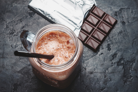 Chocolate smoothie in a jar, protein milkshake, healthy eating on dark background.の写真素材
