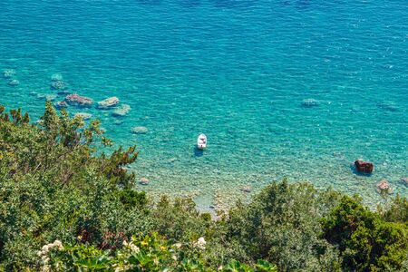 View from above to the Adriatic sea and small boat in the water, Montenegro.の写真素材