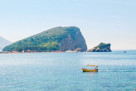 Colorful summer seascape with turquoise water of Adriatic sea and Sveti Nikola island near Budva...