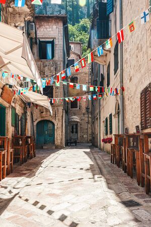 Old historical buildings with street cafe in the central district of ancient city Kotor in Montenegro.の写真素材
