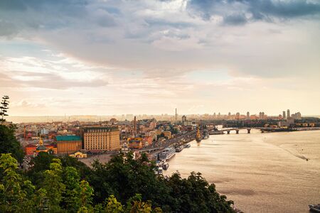 View from above to the Kyiv city and Dnipro river, Ukraine. cloudy sky before rain with warm sunset light.の写真素材
