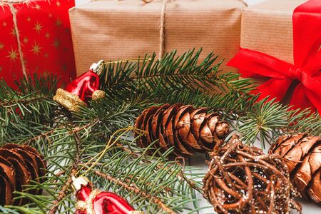 Christmas or New Year wooden background, gift boxes and pine branch with decorations.の写真素材