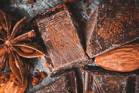 Chocolate cubes, star anise and almond, close-up, top view.の写真素材
