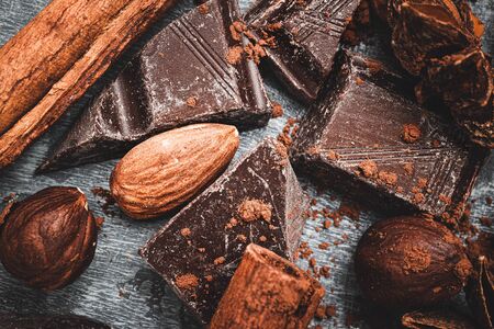 Chocolate cubes, star anise, cinnamon stick and nuts, top view.の写真素材