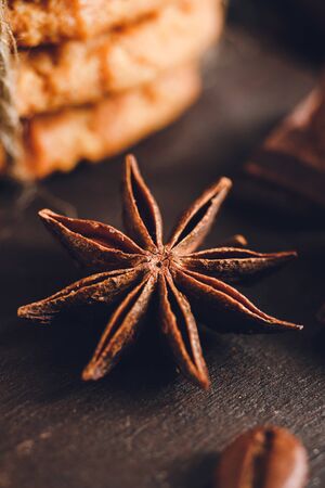 Star anise on dark wooden board, close-up view.の写真素材