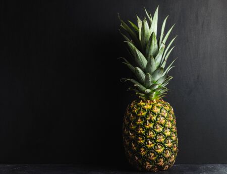 One whole pineapple on dark background.の写真素材