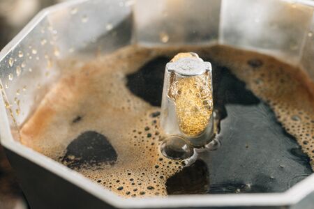 Brewing coffee in a moka pot, close-up view.の写真素材