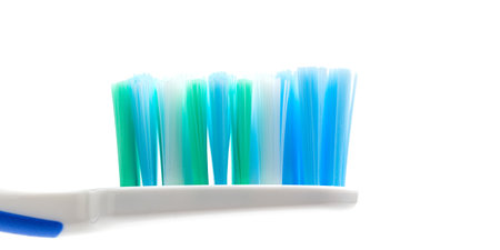 Toothbrush head close-up view, isolated on white background, macro.