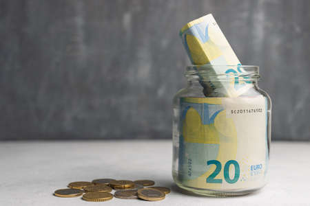 Euro banknotes in a glass jar, saving money concept with copy spaceの写真素材