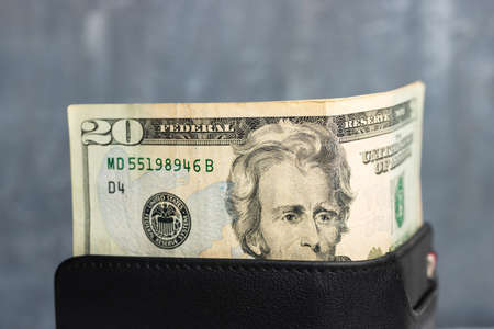 Wallet with twenty dollar bill money at dark background.の写真素材