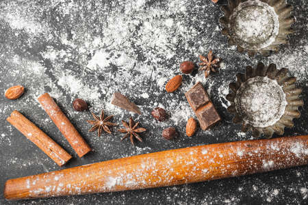 Baking concept, cupcake form and food ingredients on a dark background, prepare for cooking, top view.の写真素材