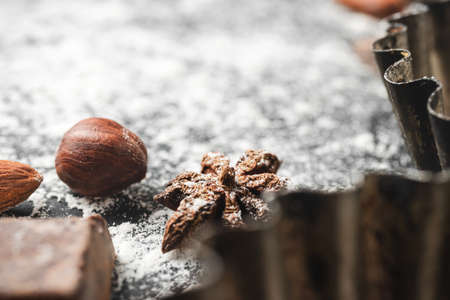 Baking concept, focus on a star anise, close-up view, food ingredients on a dark background.の写真素材