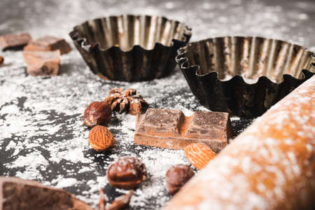 Baking concept, focus on a star anise, close-up view, food ingredients on a dark background.の写真素材