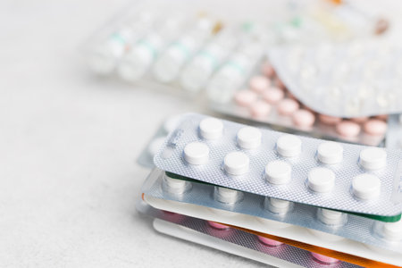 Pile of various pills and tablets in a blister pack on white background, healthcare and medicine...