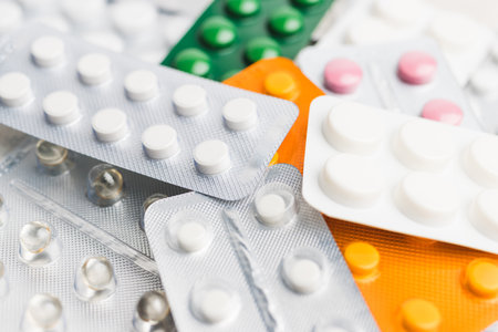 Pile of various pills and tablets in a blister pack on white background, healthcare and medicine concept.の写真素材